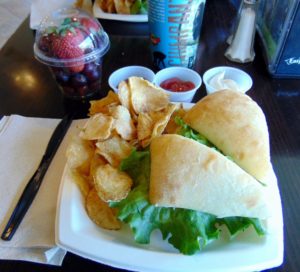 Turkey Club on Ciabatta Homemade Herbed Chips Fresh Fruit Cup Macaw Landing Grill Tulsa Zoo